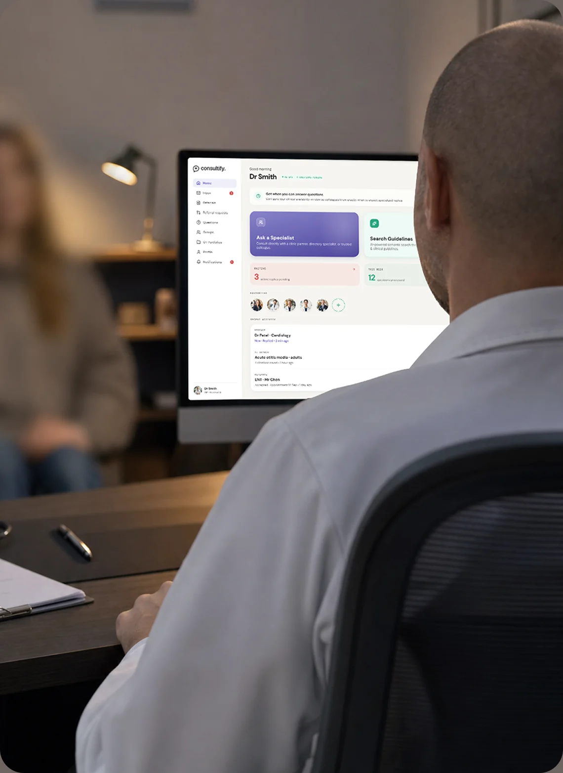 A GP reviewing the Consultify dashboard at his desk